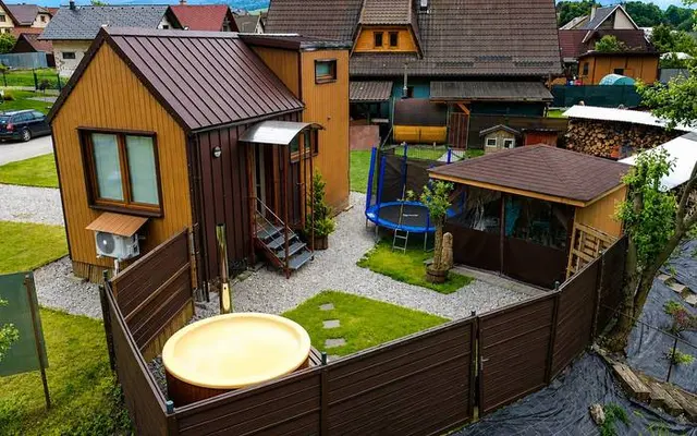 Pohľad zhora na chatu, oplotený dvor s kaďou a altánok